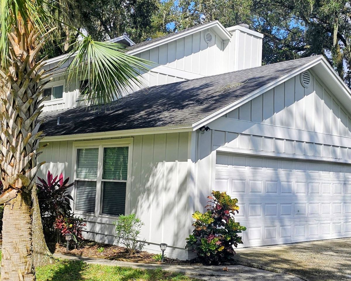 Two-story home with James Hardie board and batten siding installed by Better Home Improvement in Jacksonville, FL