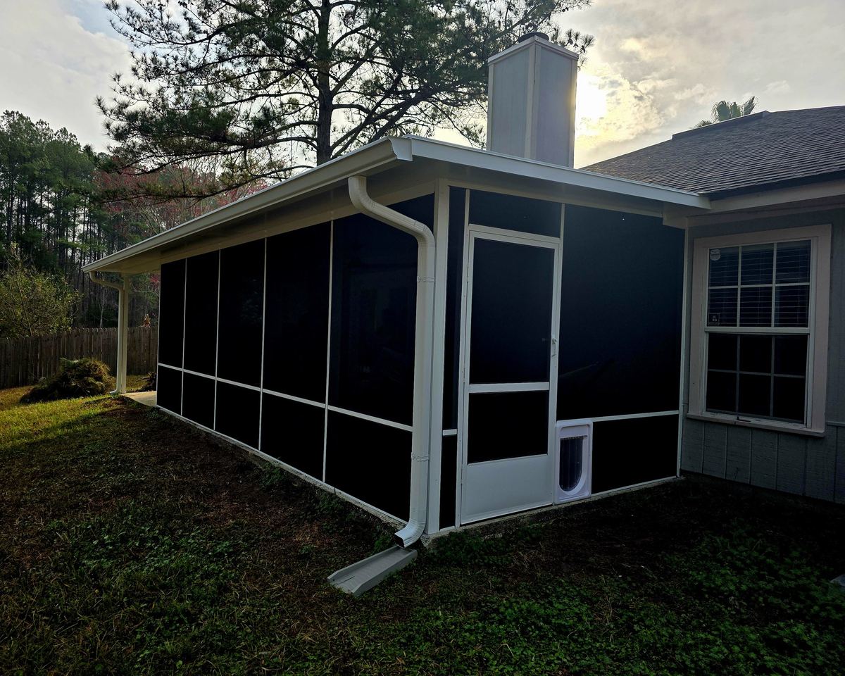Screen room with a solid roof, built by Better Home Improvement in Orange Park, FL
