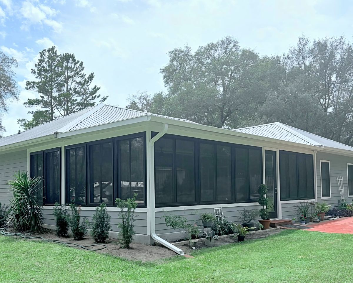 Sunroom addition with windows across its walls on the side of a home, built by Better Home Improvement in Starke, FL
