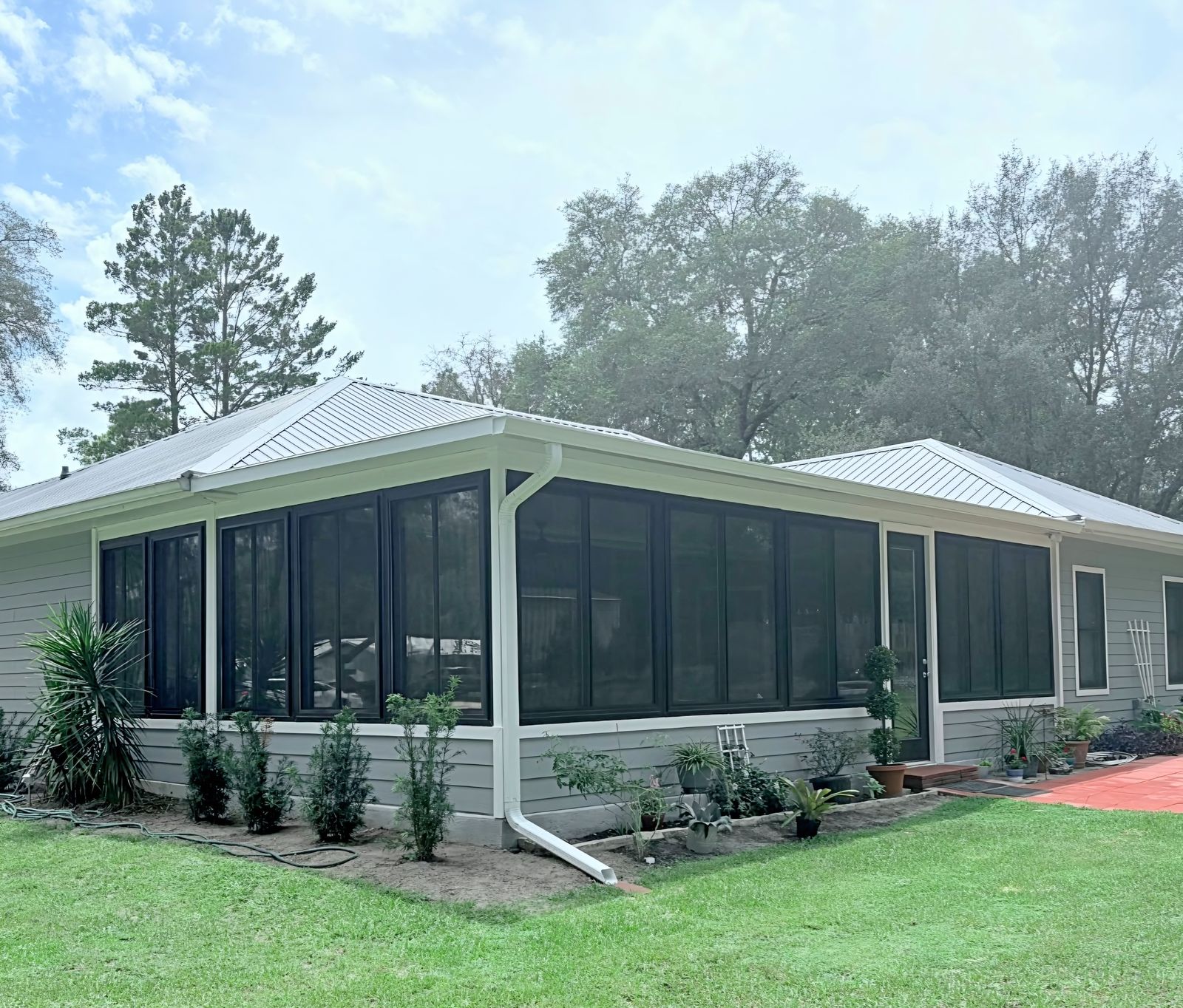 Sunroom addition with windows across its walls on the side of a home, built by Better Home Improvement in Starke, FL
